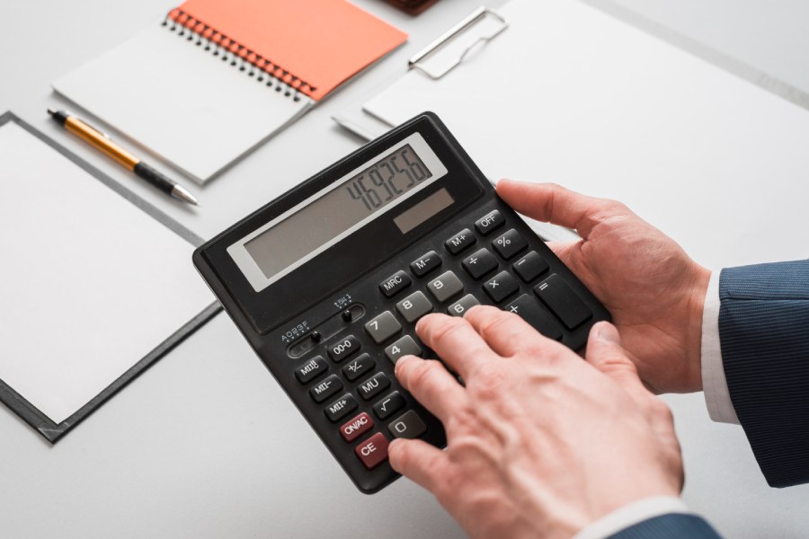 Business concept with hands using calculator